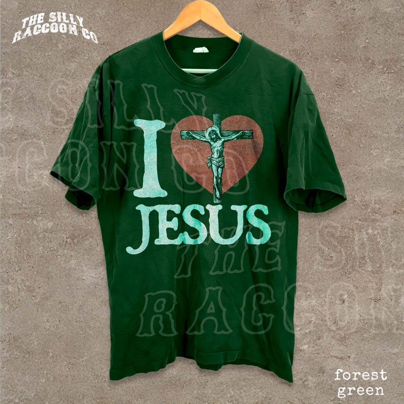 A green t-shirt with a graphic design featuring a cross and the text "I love Jesus" printed on it.