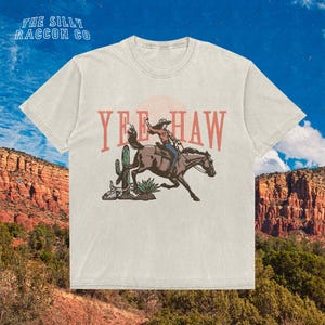 a t - shirt with a cowboy riding a horse