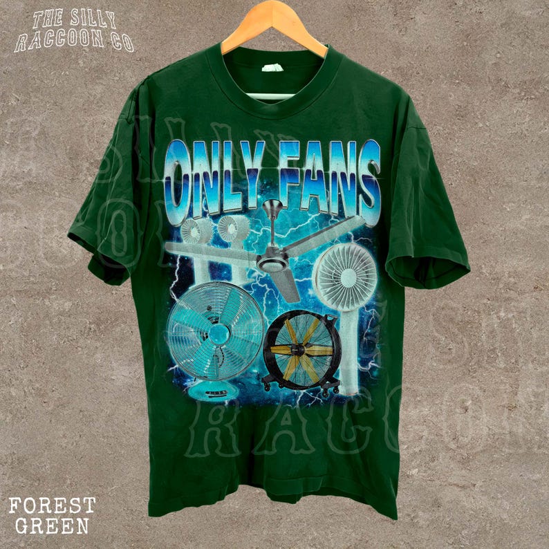 A green t-shirt with a graphic design featuring a fan and various other objects, along with the text "ONLY FANS" prominently displayed.