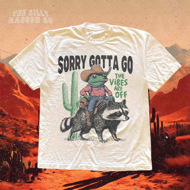 a white t - shirt with a picture of a man riding a racoon