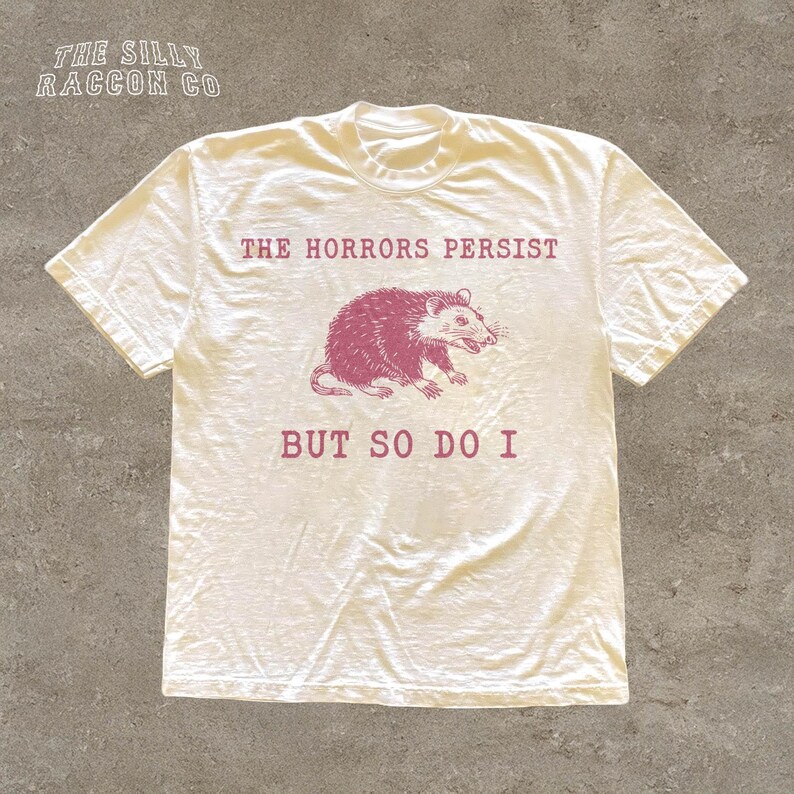A white t-shirt with a graphic design and text printed on it.