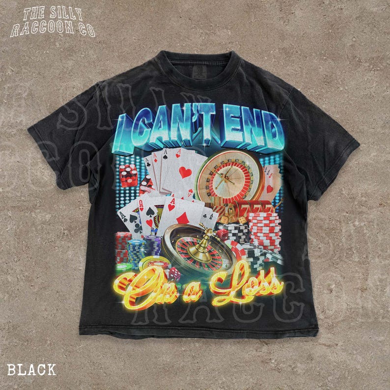 A black t-shirt with a graphic design featuring various casino-related elements, including playing cards, a roulette wheel, and stacks of poker chips. The text on the t-shirt reads "I CAN'T END ON A LESS THAN 500 CHARACTERS".