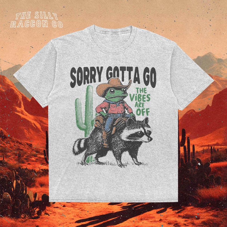 a t - shirt with a picture of a man riding a racoon