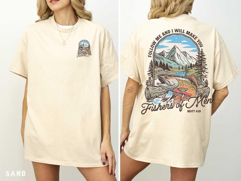 a woman wearing a cream-colored t-shirt with a graphic design on the back. The design includes a fish, mountains, and a Bible verse.