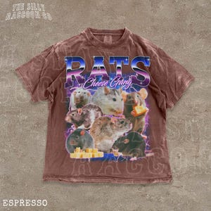 A brown t-shirt with a graphic design featuring a group of rats and cheese, along with the text "RATS Cheese Gang" and "ESPRESSO".