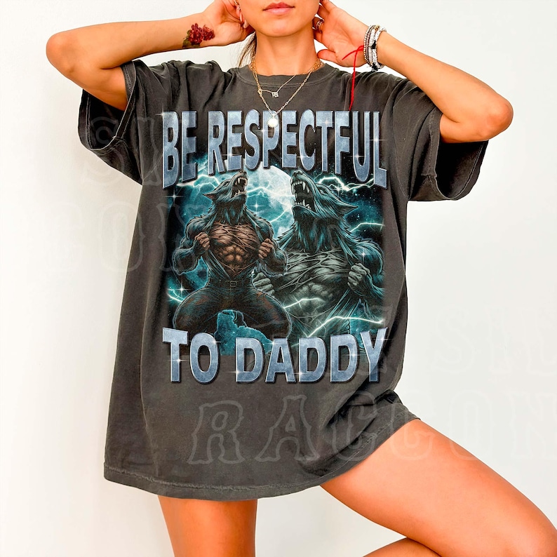 A person wearing a black t-shirt with a graphic design featuring two werewolves and the text "BE RESPECTFUL TO DADDY".