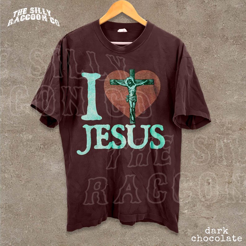 A dark brown t-shirt with a graphic design featuring a cross and the text "I love Jesus" printed on it.