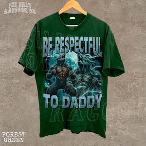 A green t-shirt with a graphic design featuring two werewolves and the text "BE RESPECTFUL TO DADDY" printed on it.