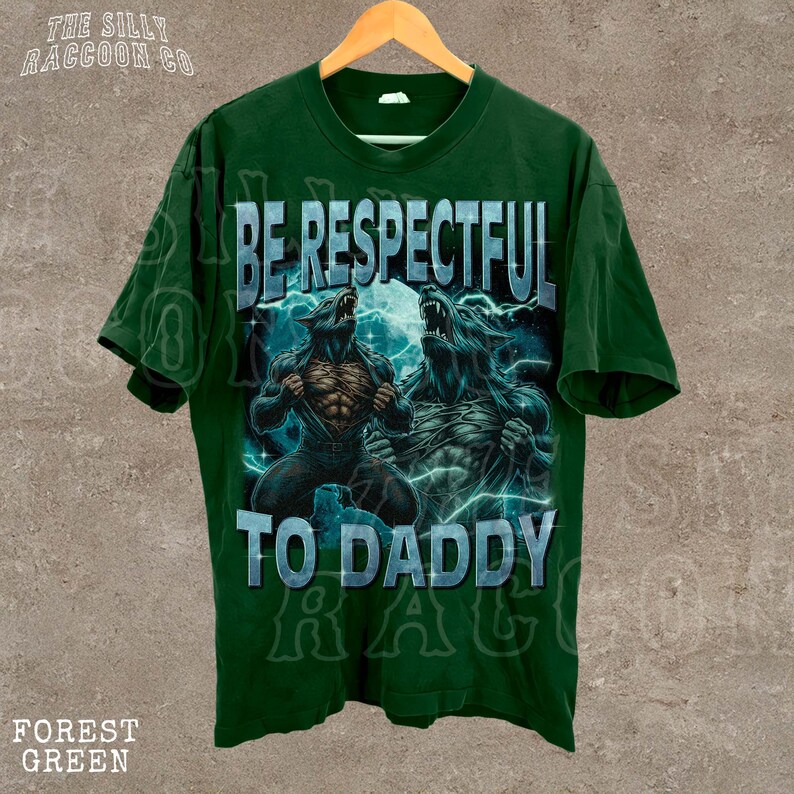 A green t-shirt with a graphic design featuring two werewolves and the text "BE RESPECTFUL TO DADDY" printed on it.