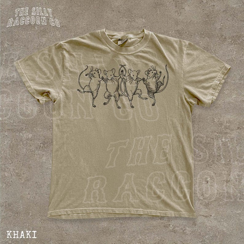 A khaki t-shirt with a graphic design of five cartoon mice dancing together.