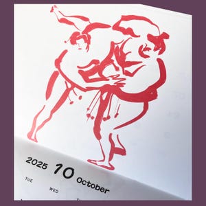 May include: A red ink illustration of two sumo wrestlers in a match. The image is on a white calendar page with the date "2025 10 October" printed below.