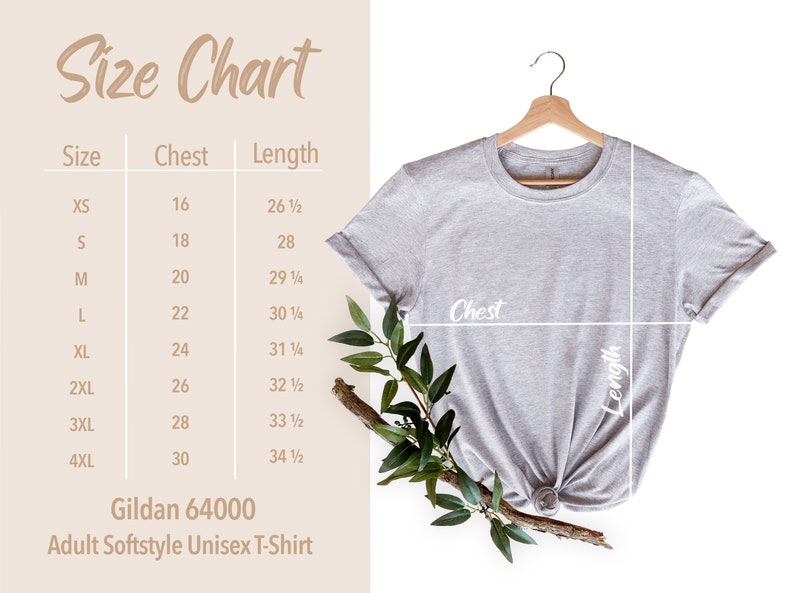 May include: A light grey Gildan 64000 Adult Softstyle Unisex T-Shirt hangs on a wooden hanger. A size chart shows chest and length measurements in inches for sizes XS to 4XL. Greenery accents the shirt.