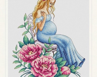 May include: A cross-stitch pattern of a pregnant woman in a blue dress sitting on a chair surrounded by pink flowers.