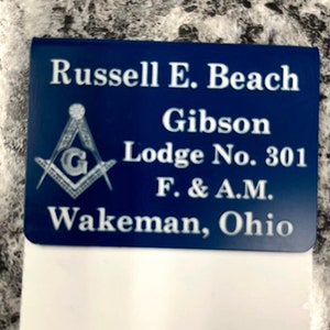 May include: A blue and white Masonic membership card with the text "Russell E. Beach Gibson Lodge No. 301 F. & A.M. Wakeman, Ohio".