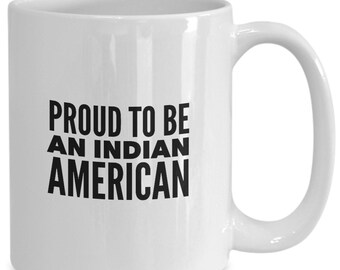 May include: White ceramic coffee mug with black text that reads "PROUD TO BE AN INDIAN AMERICAN".
