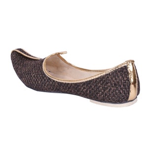 May include: Brown woven fabric shoes with a gold trim around the edge. The shoes have a pointed toe and a flat sole.