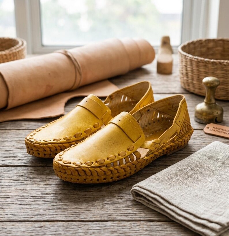 May include: A pair of yellow leather loafers featuring a woven design along the sides and toe box, with a slip-on style and cut-out details. The shoes have a thick braided leather trim around the base and a smooth leather upper construction.