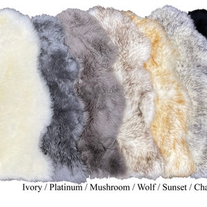 May include: A variety of sheepskin rugs in different colors, including ivory, platinum, mushroom, wolf, sunset, charcoal tip, and black. The rugs are arranged in a row, with the ivory rug at the front and the black rug at the back. The text "Classic" is visible at the bottom left of the image.