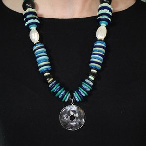 Black and white circular agate pendant with shell and horn