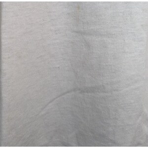 May include: A plain white t-shirt with a smooth, slightly textured surface.