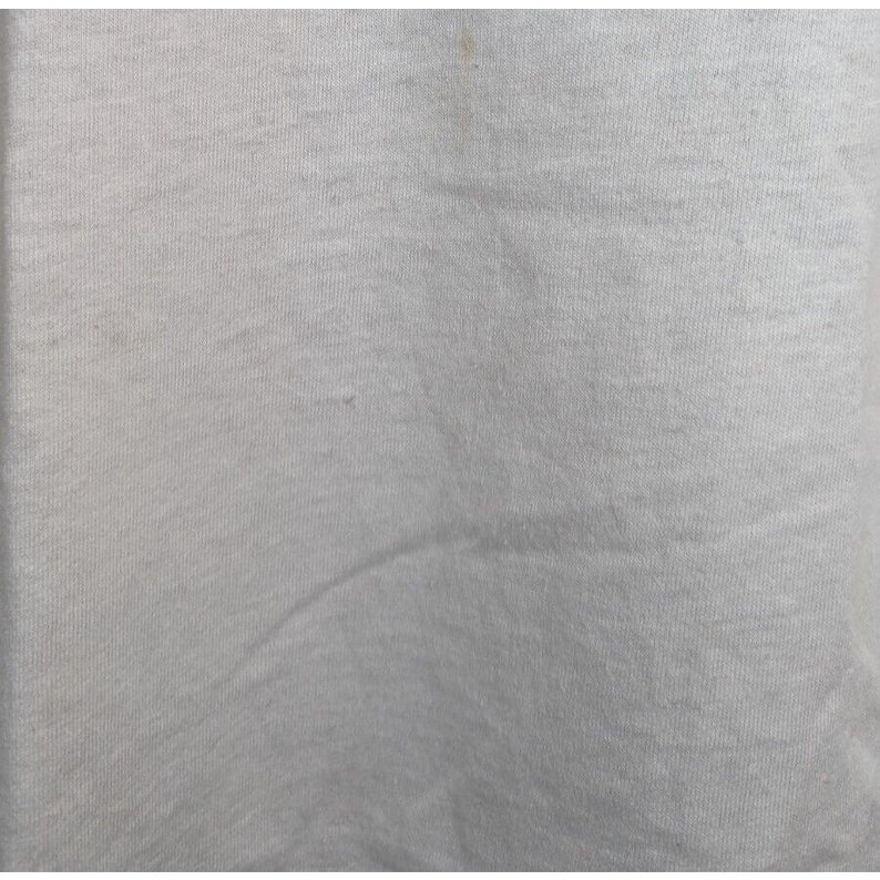 May include: A plain white t-shirt with a smooth, slightly textured surface.