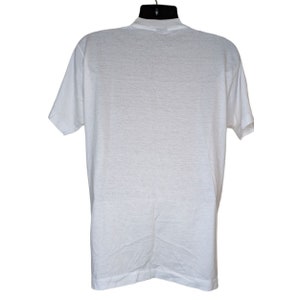 May include: A white t-shirt with a crew neck and short sleeves.