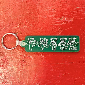 May include: Green keychain with five dancing bears in white, with the text "© 2000 G.D.P." at the bottom.