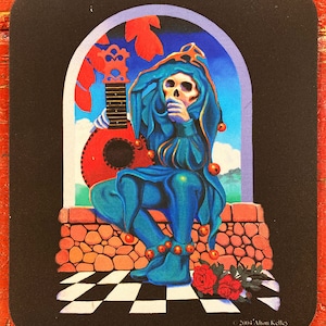 May include: A blue jester with a skull face sits in a stone archway holding a red guitar. The jester is wearing a blue and gold costume with bells on the sleeves and shoes. The jester is looking down at the guitar. The background is a blue sky with clouds. The image is signed "© 2004' Alton Kelley".