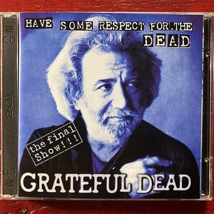May include: A CD case featuring a portrait of a man with a beard, set against a blue background. The text "HAVE SOME RESPECT FOR THE DEAD" is at the top, with "the final Show!!!" and "GRATEFUL DEAD" below.