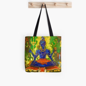 May include: A tote bag featuring a colorful painting of Shiva, a Hindu deity, sitting in a meditative pose on a tiger skin. He is holding a trident and a cup, and is surrounded by green and yellow foliage. The background includes the Om symbol and other Hindu symbols.
