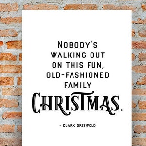 May include: A white poster with black text that reads "Nobody's walking out on this fun, old-fashioned family Christmas."  The text is in a vintage font.  The poster is signed "Clark Griswold".