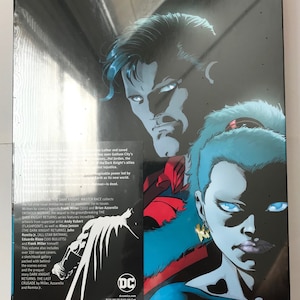 May include: A DC Comics graphic novel cover featuring Batman, Superman, and a female character with blue skin and white eyes. The title "Master Race" is printed in large, bold letters at the bottom of the cover. The cover is a dark blue and red color scheme.