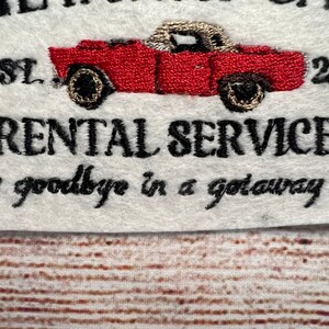 May include: Embroidered logo for a car rental company called "Get Away Cars" established in 2007. The logo features a red vintage car with the text "Rental Services" and the tagline "Say goodbye in a getaway car."