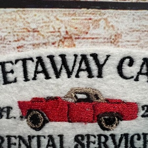 May include: Embroidered logo for a car rental business called "Getaway Car" established in 2017. The logo features a red convertible car with black wheels and a white top.