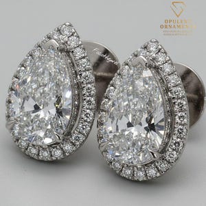 May include: A white ceramic mug with a black handle and the text "But First, Coffee" in a bold, black font. The mug is sitting on a wooden surface. The mug is approximately 4 inches tall.