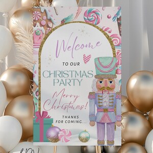 May include: A Christmas party welcome sign featuring a nutcracker illustration. The sign has the words "Welcome to our Christmas Party" and "Merry Christmas!" in a decorative font. The sign is surrounded by gold and white balloons.