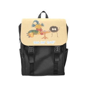 May include: Black backpack with a beige flap featuring an illustration of a caterpillar and a fluffy black creature having tea. The text "tea for two?" is printed on the flap.