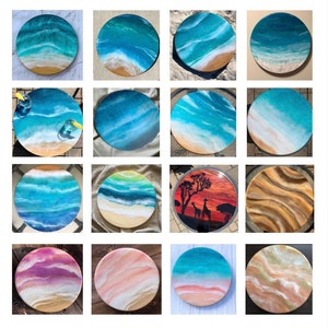 May include: A collection of round resin art pieces with ocean wave and beach scenes. Some pieces feature a wooden base, while others have a clear resin base. The colors are vibrant and the details are intricate.