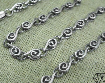 May include: A silver chain necklace with a unique spiral link design. The chain is made of small, interconnected spirals that create a flowing, elegant look.