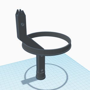 May include: A black 3D printed cup holder with a ring and a hook. The hook has a serrated edge.