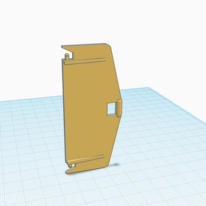 Könnte beinhalten: Ein beigefarbenes Kunststoffteil mit rechteckiger Form und einer kleinen rechteckigen Öffnung. Das Teil hat an einer Seite eine abgerundete Kante und an der anderen Seite eine spitze Kante.