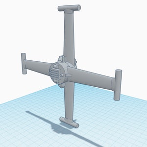 May include: A gray model of a four-armed spacecraft with a central engine and a grid pattern on the floor.