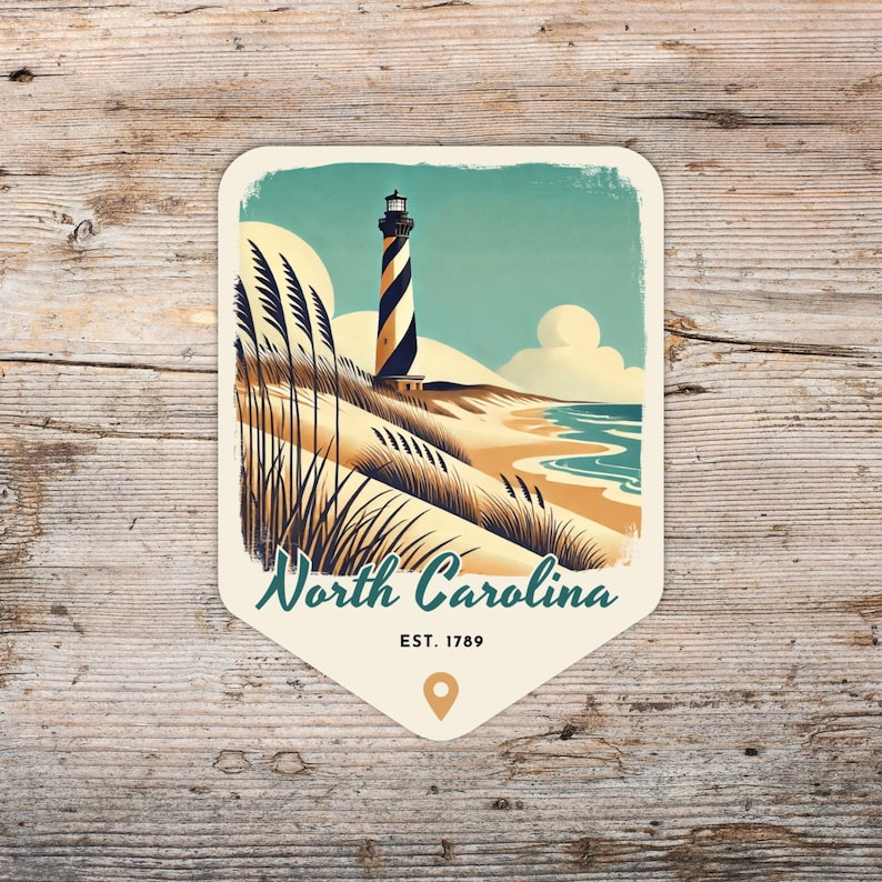 May include: A vintage-style illustration of a lighthouse on a sandy beach with blue water and green grass. The text "North Carolina EST. 1789" is below the image.