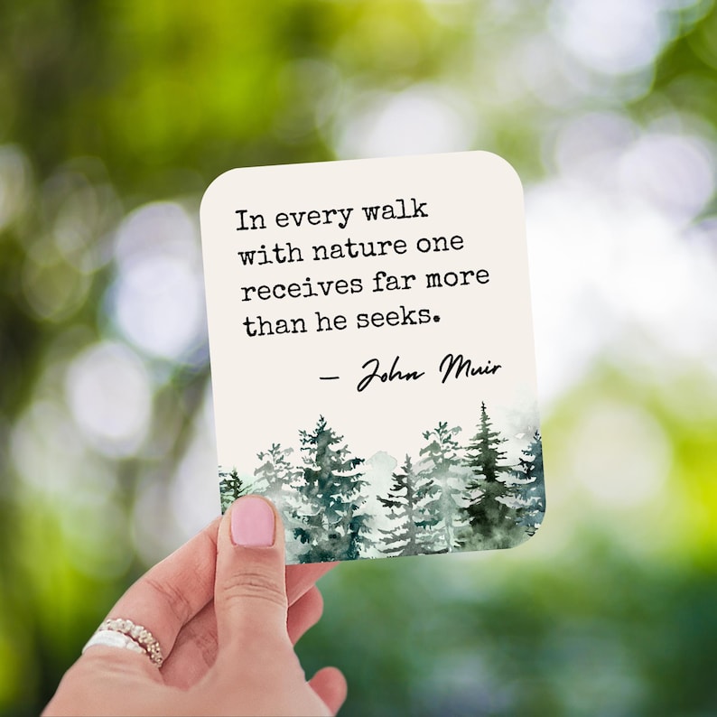 May include: A white card with a quote by John Muir about nature. The quote reads: "In every walk with nature one receives far more than he seeks." The card has a watercolor illustration of a forest.