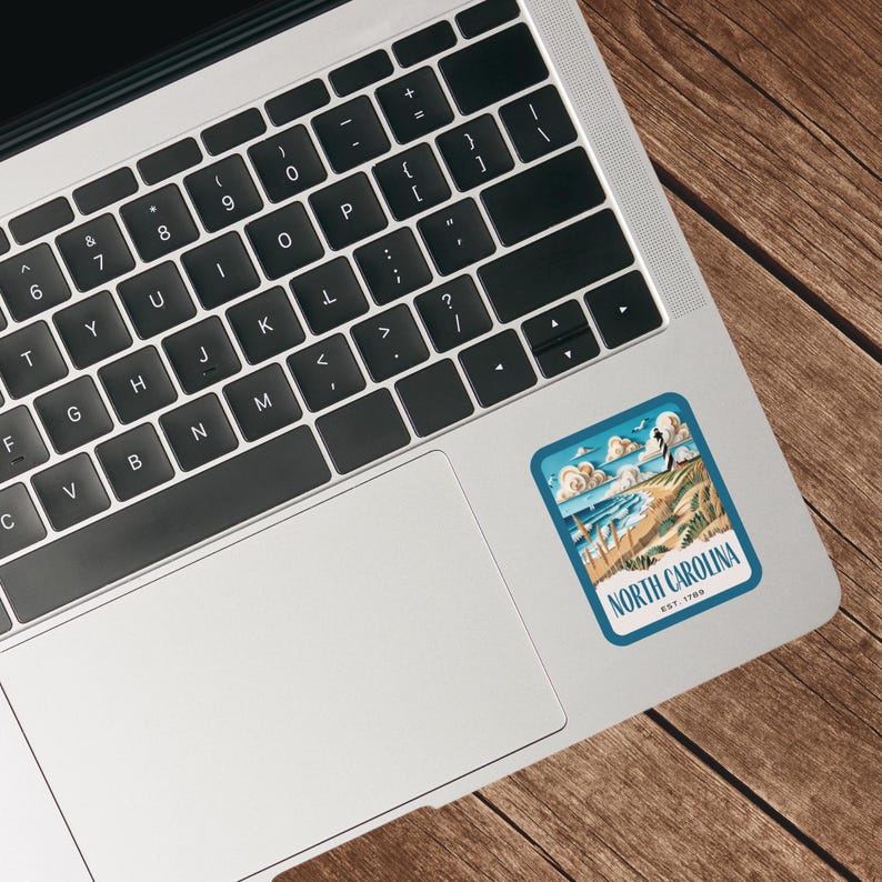 May include: A blue and white sticker with a vintage illustration of a beach scene and the text "NORTH CAROLINA EST. 1789".