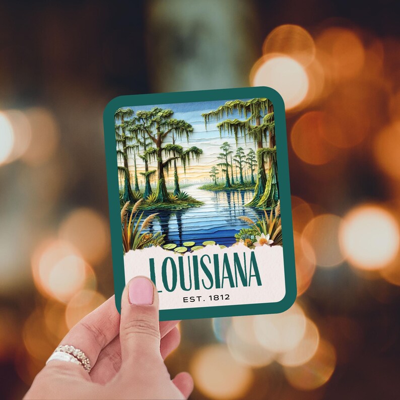 May include: A teal blue sticker with a vintage illustration of a swamp scene with cypress trees and a river. The text "LOUISIANA EST. 1812" is printed in white on the sticker.