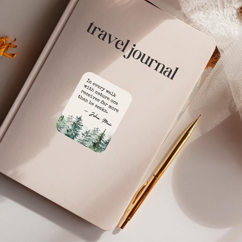 May include: A travel journal with a quote about nature by John Muir. The quote reads "In every walk with nature one receives far more than he seeks." The quote is printed on a sticker with a watercolor illustration of a forest.