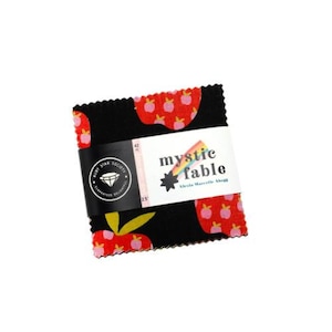 May include: A stack of 42 fabric squares with pinked edges, featuring a black background with a repeating red apple pattern. A white paper band wraps around the centre, printed with the text mystic fable, Ruby Star Society, and 6.35 cm.