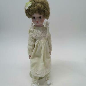 Victoria Impex Porcelain Wind Up Musical Doll Yellow Dress