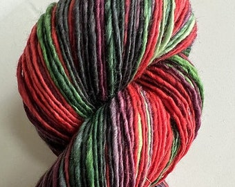 May include: A skein of yarn with red, green, and black stripes. The yarn is made of a soft, natural fiber and is perfect for knitting or crocheting.